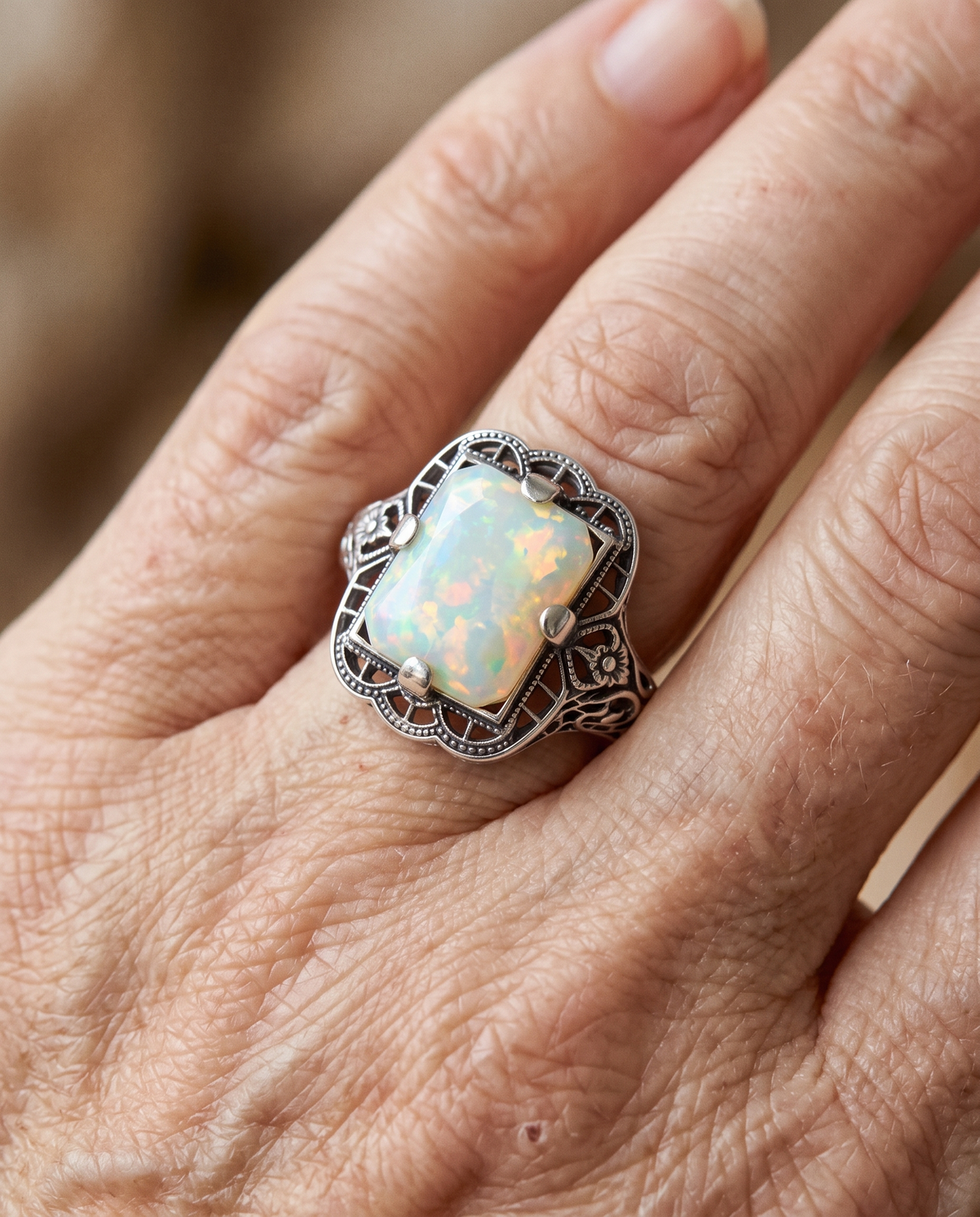 White Opal Filigree Silver Ring worn on a model