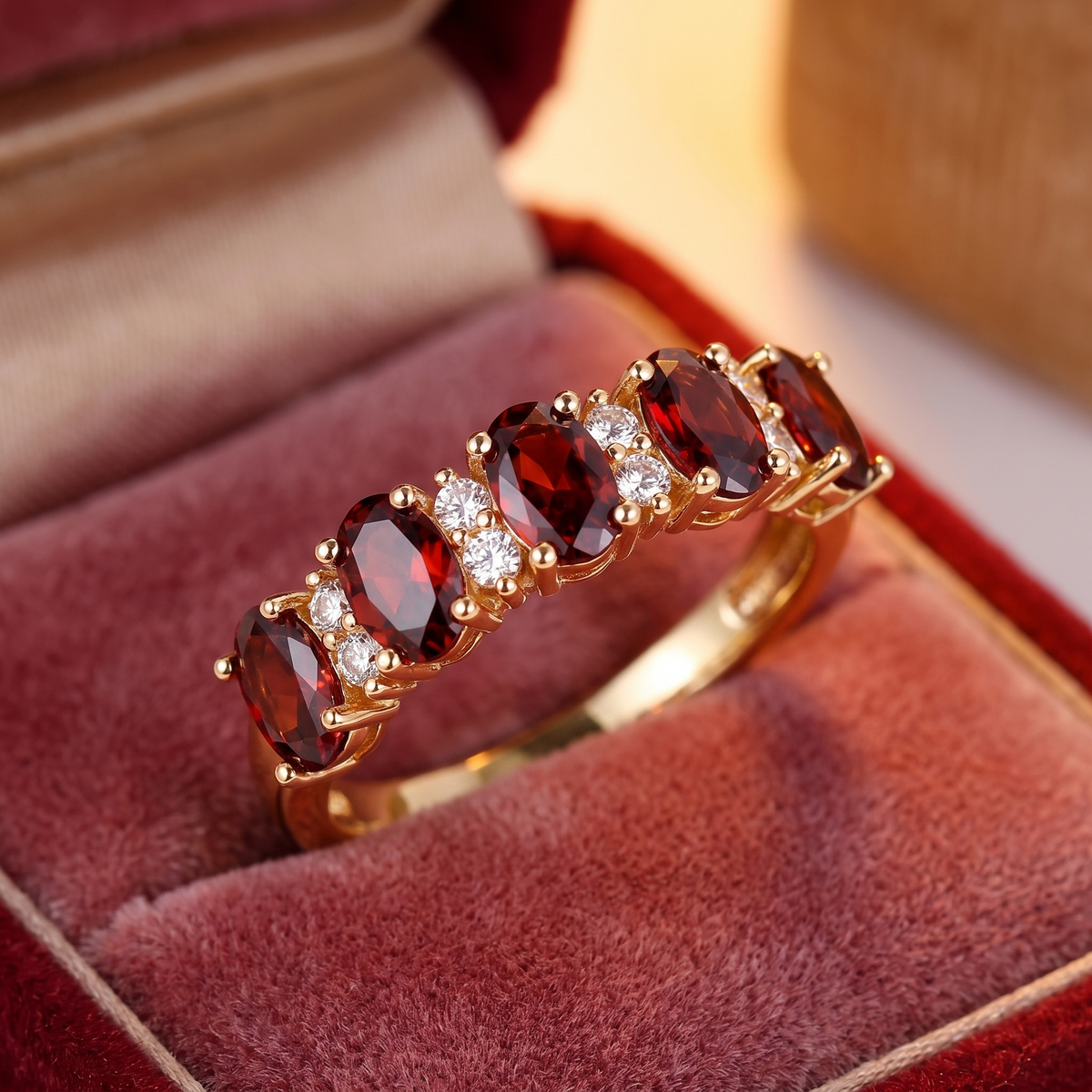 Gold ring with red crystal inlays