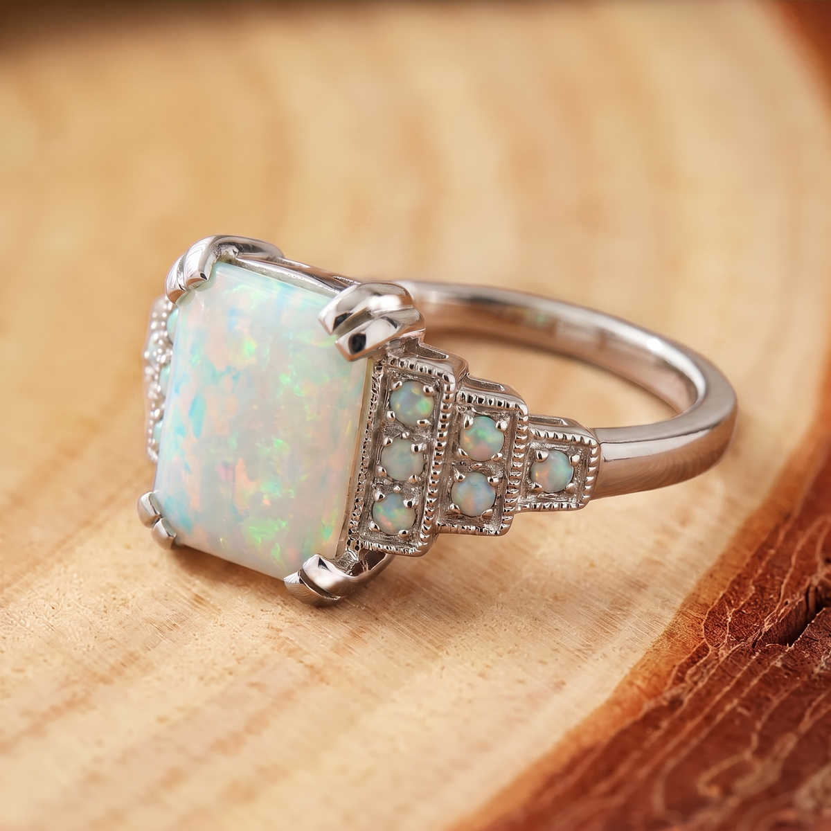 White Opal Art Deco Silver Ring on a tree-trunk slab